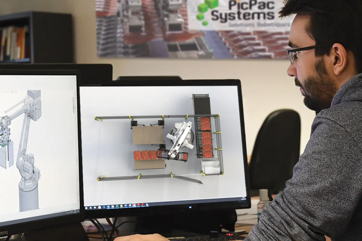 Équipe PicPacSystems travaillant sur la conception d’une installation robotisée